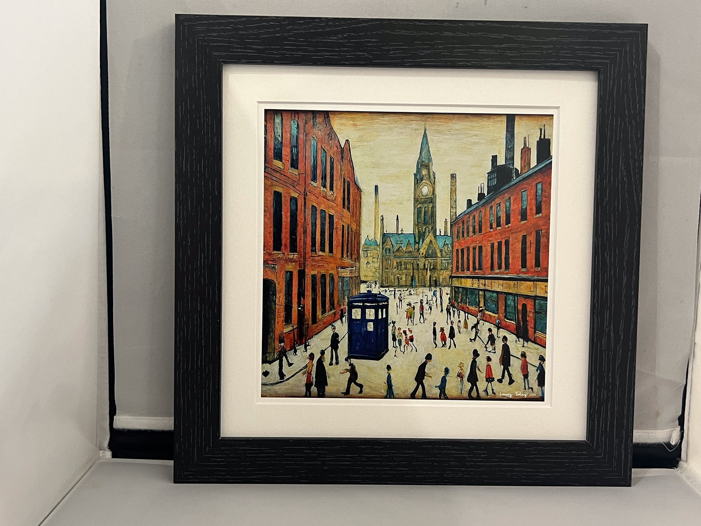 The Doctor Who Comes To Town - Giclée Art Print 12" Square Black Frame. Stylish Image in the Style Of LS Lowry. Ideal Gift.